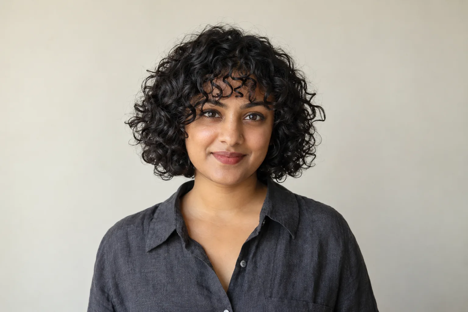 Curly bob with a soft ringlet fringe near the eyebrows