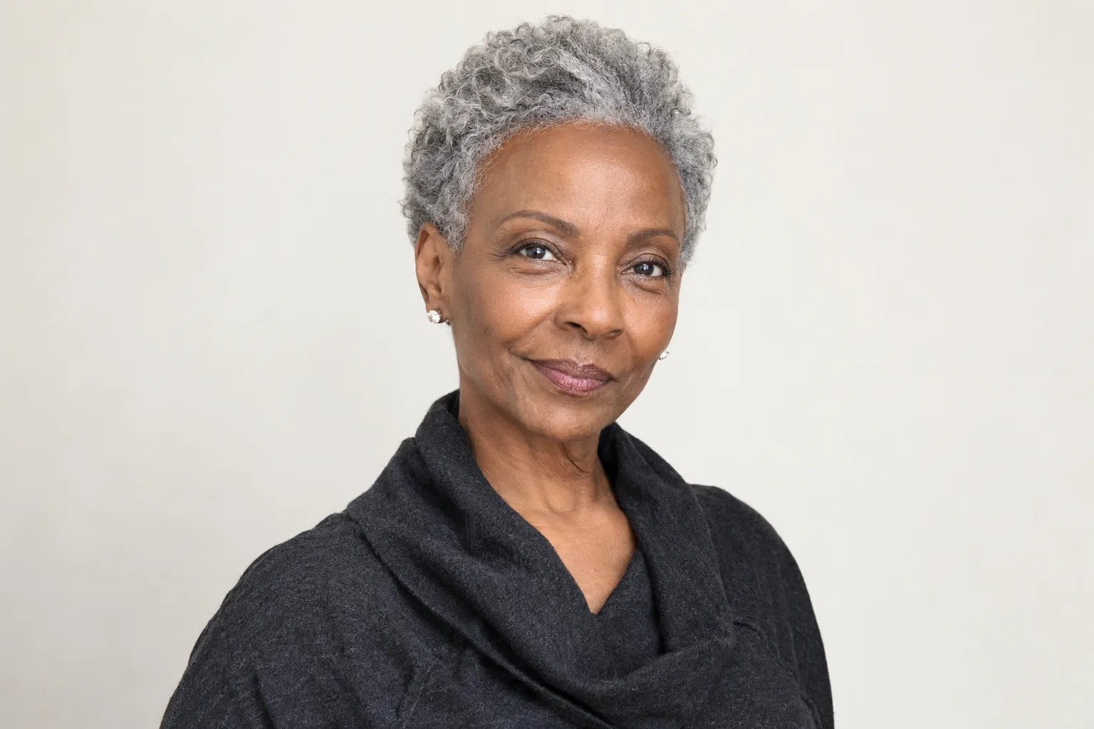 Original older adult woman with a silver textured pixie, visible forehead and exposed jawline