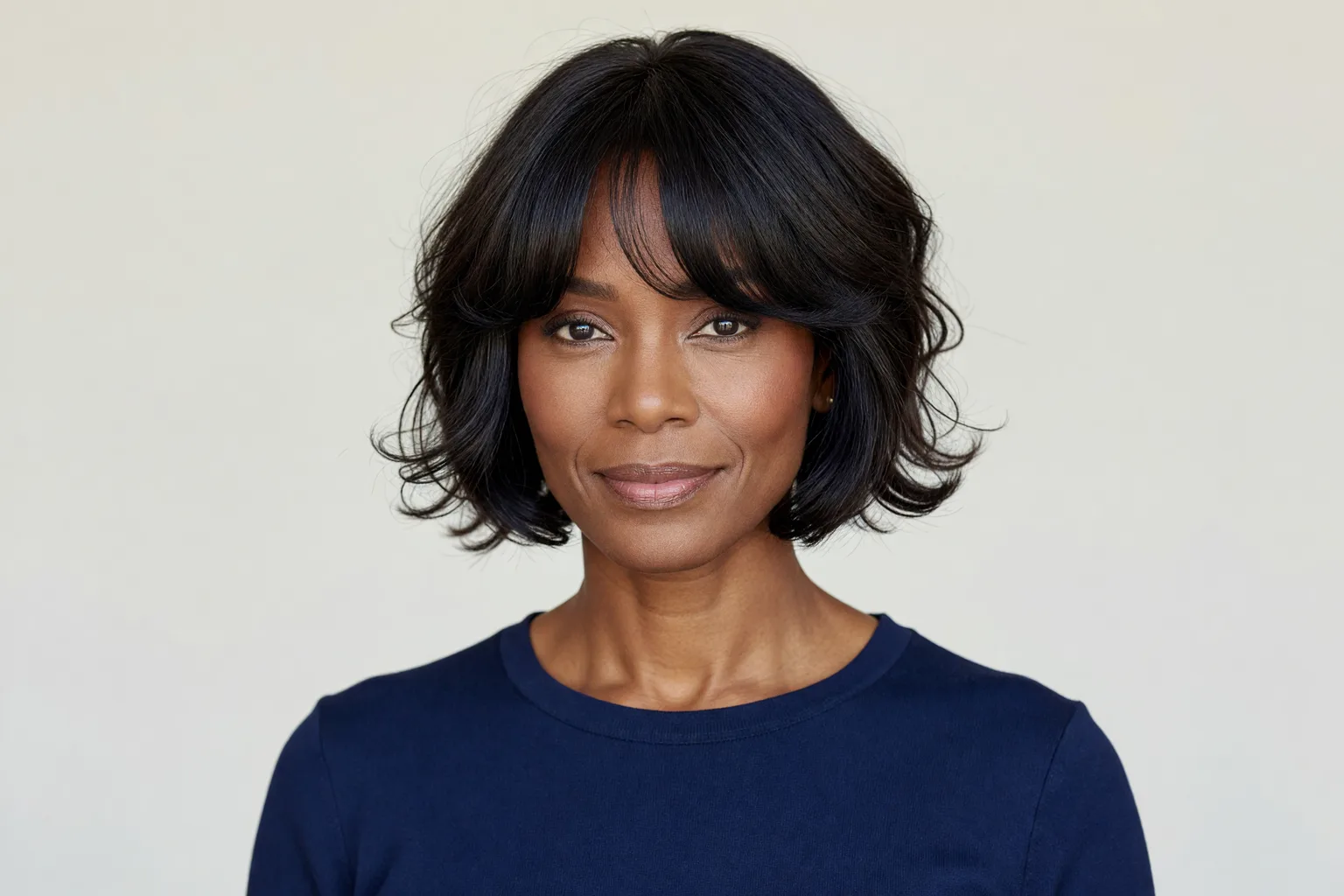 Generated portrait of a woman in her late 40s with a chin-length shag on fine dark hair and a wispy fringe